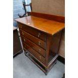 A chest of four drawers on an open leg barley twist stretcher base.