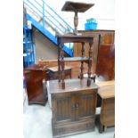 A 20th century oak linen fold cabinet with a reproduction side table and small occasional stool.(3).