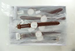 A collection of Daniel Wellington designer unisex quartz wristwatches with leather straps,