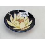 Moorcroft coaster decorated with a yellow water lily design,