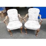 A pair of George 1st style walnut carved armchairs with RMH engraved onto the rear leg (2).