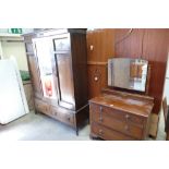 An early 20th century oak three door over two drawer wardrobe with beading and central mirror,