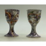 Pair of Cobridge Stoneware chalices decorated with flowers,