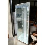 A modern corner unit / display cabinet with mirrored interior and lighting.