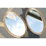 A pair of oval guilt farmed bevel edged wall hanging mirrors (2)
