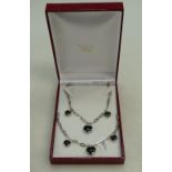 Silver ladies necklace with black & white heart shaped pendants with a matching bracelet, 34.