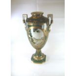 Porcelain two handled gilded vase handpainted with