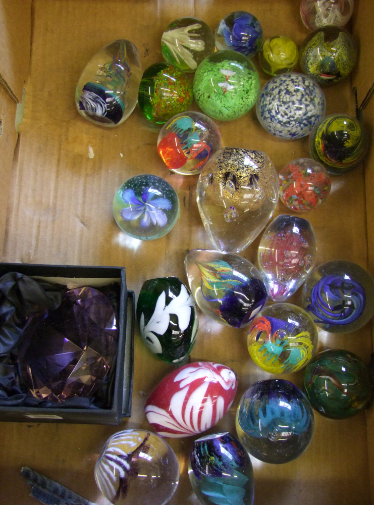 A collection of various glass paperweights