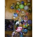 A collection of various glass paperweights