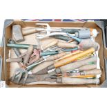 A mixed collection of hand held tools to include hammers, trowels,