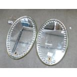 Decorative pair of oval antique fancy bevelled and circular cut mirrors,