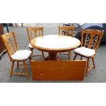 Reproduction round extending Dining Table with 1 Extra Leaf and 4 matching Chairs.
