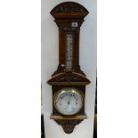 A heavily carved Edwardian Aneroid Barometer (unnamed).