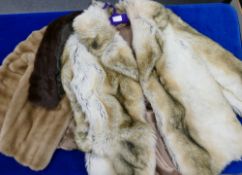 Two synthetic fur jackets together with a similar mink stole and matching hat.