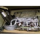 A large mixed collection of vehicle parts including a roof rack and tension wire.