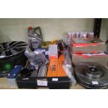 A large mixed collection of vehicle related items to include disc brakes, spark plugs an alloy