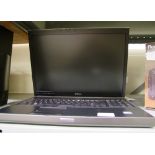 A Dell Precision M6400 laptop with software and cables.