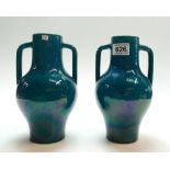 A pair of pottery two handled vases in a