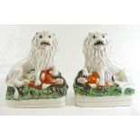 Pair - Lion fighting Man Staffordshire figures, 23.5 cm.