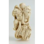 19th century Japanese carved Netsuke peasant carrying son, length 7.5cm.