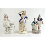 Three female Staffordshire figures - girl with rabbit, two girls and dancing girl. 16.5 - 19.