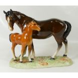 Beswick Horse and Foal on a ceramic plinth.
