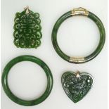 A collection of Jade jewellery including two carved pendants and two bangles (4)