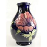 Moorcroft vase in Anemone design on dark blue ground, silverline mark to base,