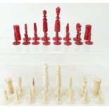 19th century carved bone chess set, one set in natural bone colour and the other set stained in red,