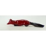 Royal Doulton stalking / laying Flambe Fox signed Noke 22cm long.