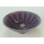 Wedgwood footed studio dish decorated with blue and pink colours inside and black colours to the