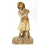 Large pottery figure of a farm girl carrying crops, dated 1917,