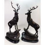 A pair of Bronze Stags on a marble base. One looking left, one looking right.