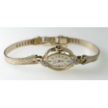 Ladies 14ct gold Omega Wristwatch set with diamonds on a gold plated bracelet . Ticking order. 12.