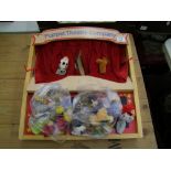 A wooden Puppet Theatre Company branded Puppet Stage with dolls/puppets.