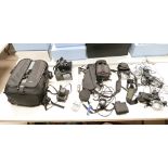 A collection of camera equipment to include LowePro camera backpack,