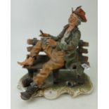 Large Capodimonte figurine of a man seated on a bench,