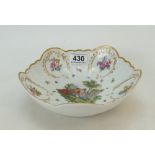 A Meissen type bowl decorated with a courting couple and butterflies.