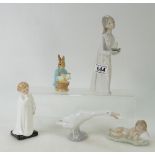 Three Lladro figures of a girl holding a candle, a white goose and a young boy sleeping,