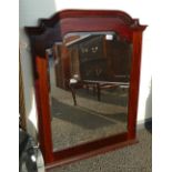 20th Century mahogany framed shaped beveled edged over mantle mirror