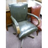 Vintage desk office chair finished in green Rexine fabric.