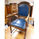 1930's carved oak arm chair with studded leather