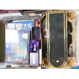 A collection of household items including books, games, Harry Potter figures, brass fire fender,