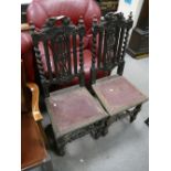 A pair of Victorian ebonised oak gothic revival high back chairs