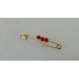 18ct gold bar brooch set with orange stones, 1.