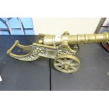 A vintage brass model of a cannon