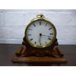 Old brass mantle clock on carved oak base
