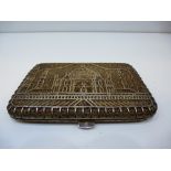 Indian white coloured metal filigree cigarette case depicting Taj Mahal, unmarked 11.5cm wide