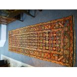 Antique Persian geometric runner having repeated decoration with a brown field 276cm x 99cm