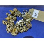 Heavy yellow coloured metal charm bracelet hung with 4 sovereigns, 2 half sovereigns, 9ct & 18ct